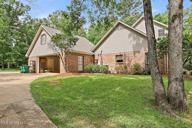 1507 W Flowers Rd, Terry, MS 39170 - traditional-style house with brick siding, concrete driveway, and a front lawn