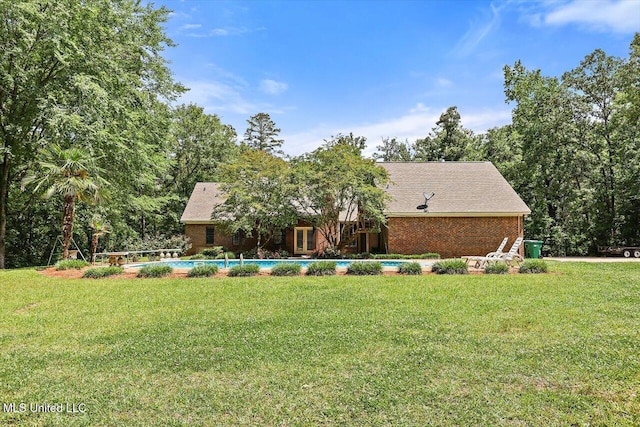 1507 W Flowers Rd, Terry, MS 39170 - view of front facade with a front yard, brick siding, and an outdoor pool