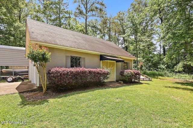 1507 W Flowers Rd, Terry, MS 39170 - view of property exterior featuring a lawn and a shingled roof