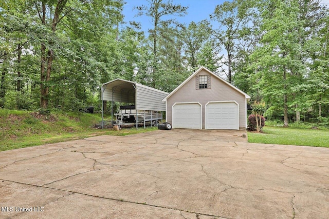 1507 W Flowers Rd, Terry, MS 39170 - detached garage with a carport and view of scattered trees