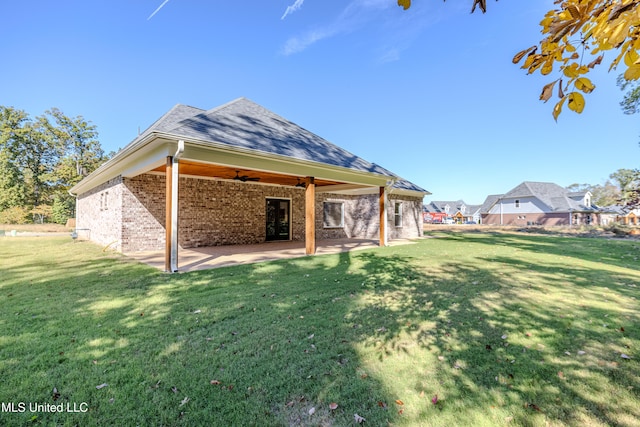 back of house with a yard, a patio, and ceiling fan