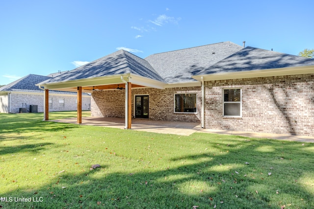 back of house featuring a yard, a patio, and central AC