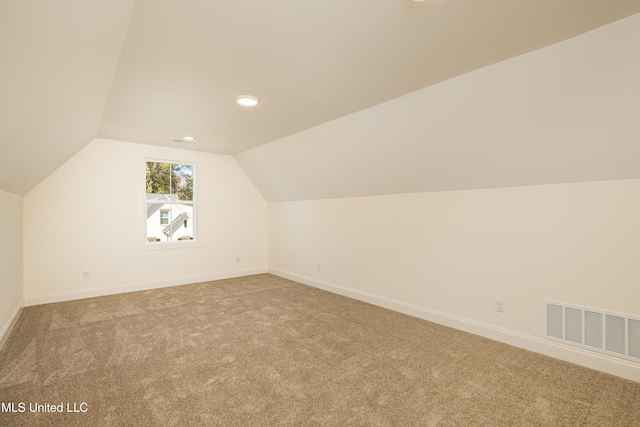 bonus room featuring carpet floors and vaulted ceiling