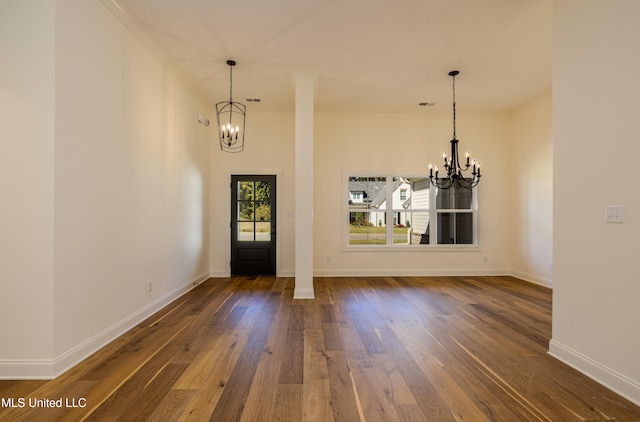 foyer entrance with dark hardwood / wood-style flooring, an inviting chandelier, and ornamental molding