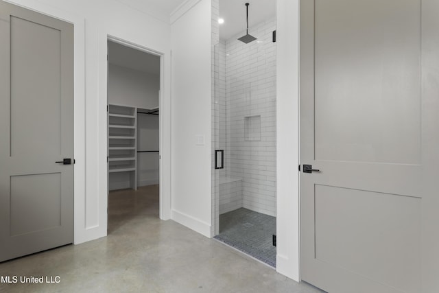 217 White Harbor Rd, Long Beach, MS 39560 - bathroom featuring crown molding, concrete flooring, baseboards, a walk in closet, and a shower stall