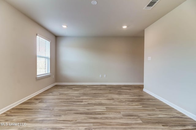 spare room featuring light hardwood / wood-style flooring