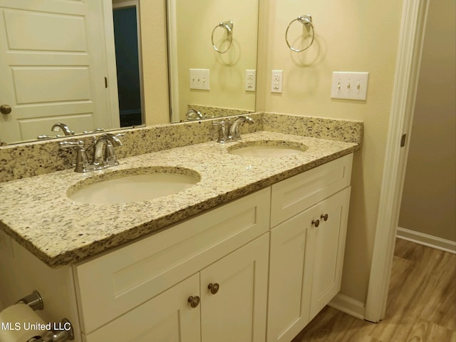 bathroom with vanity and hardwood / wood-style floors