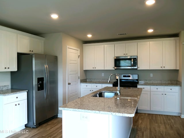 kitchen with white cabinetry, stainless steel appliances, a center island with sink, and dark hardwood / wood-style flooring