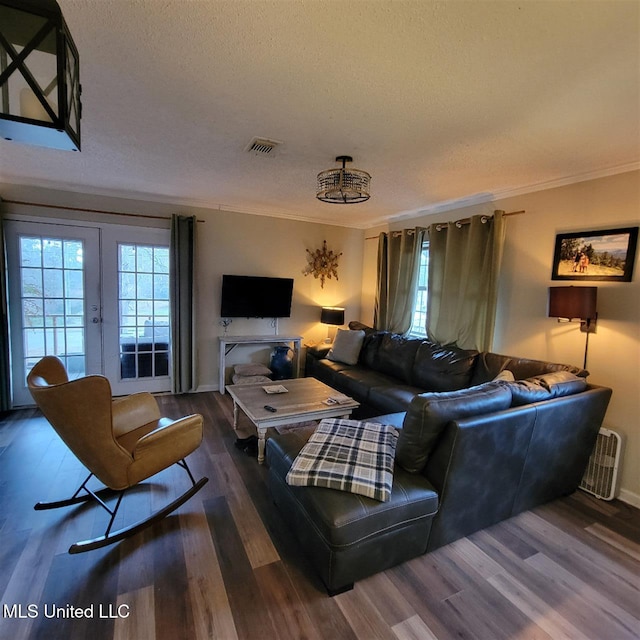 living area featuring visible vents, ornamental molding, french doors, a textured ceiling, and dark wood-style flooring