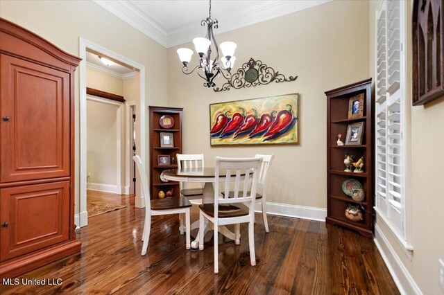 dining space featuring an inviting chandelier, crown molding, baseboards, and dark wood-type flooring