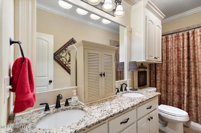 full bathroom with double vanity, ornamental molding, toilet, and a sink