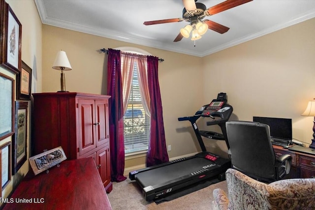 carpeted home office with baseboards, ceiling fan, and crown molding