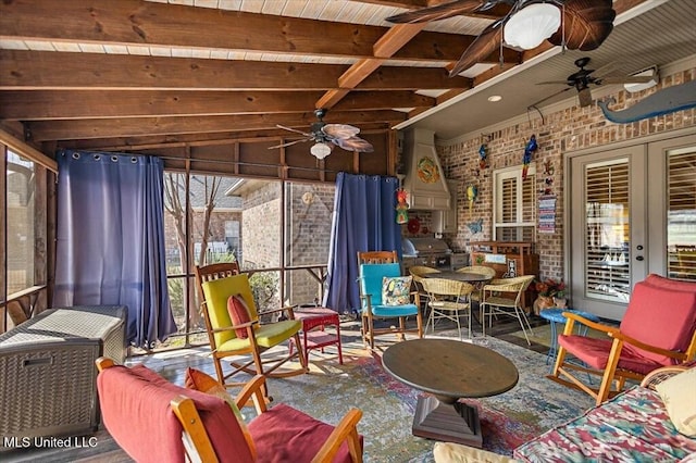 sunroom featuring french doors, beam ceiling, and ceiling fan