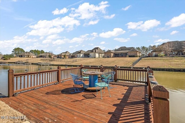 deck featuring a water view and a residential view