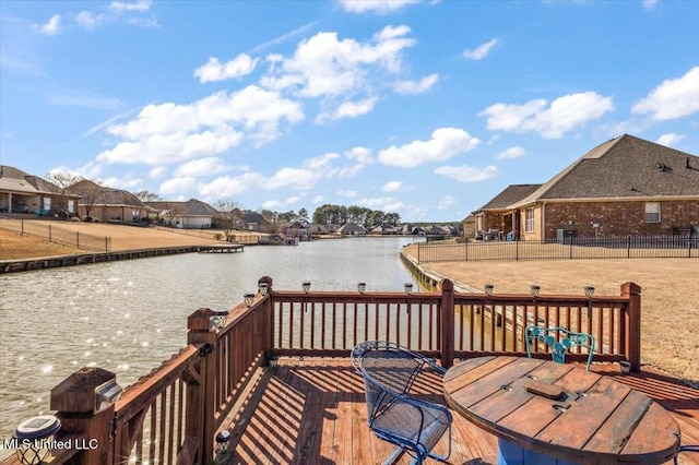 deck with a residential view and a water view