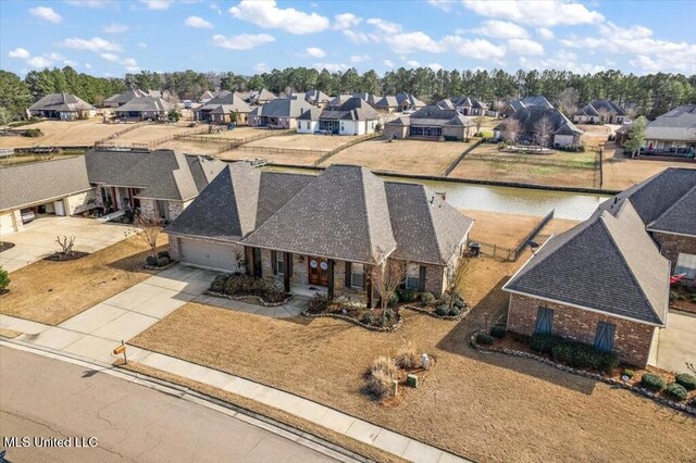 birds eye view of property featuring a residential view and a water view