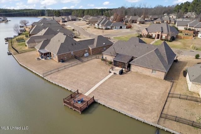 drone / aerial view featuring a residential view and a water view