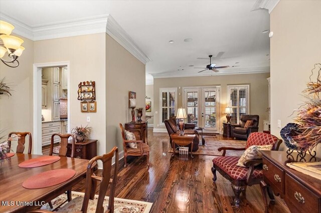 living area featuring ornamental molding, ceiling fan with notable chandelier, french doors, baseboards, and dark wood-style flooring