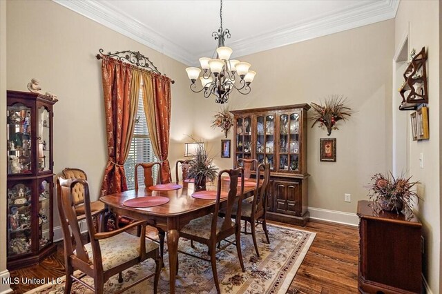 dining area featuring baseboards, an inviting chandelier, dark wood finished floors, and ornamental molding