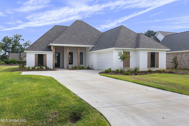 view of front of property with a front lawn and a garage