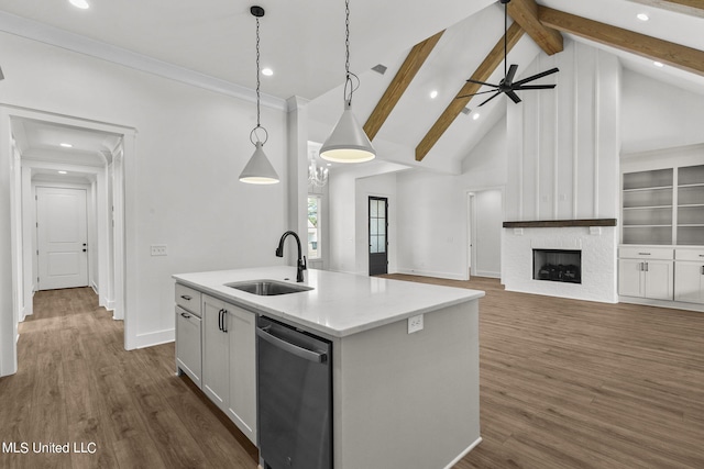 kitchen with dishwasher, dark hardwood / wood-style floors, a center island with sink, sink, and decorative light fixtures