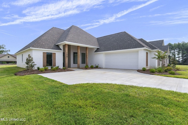 view of front of house with a front yard and a garage