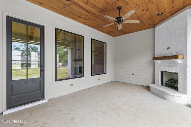 exterior space featuring an outdoor brick fireplace and ceiling fan