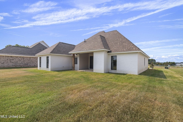 rear view of house with a lawn