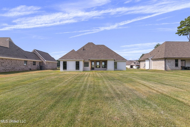 rear view of property with a yard and cooling unit