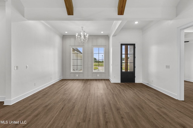 interior space with beam ceiling, ornamental molding, a notable chandelier, and dark hardwood / wood-style flooring