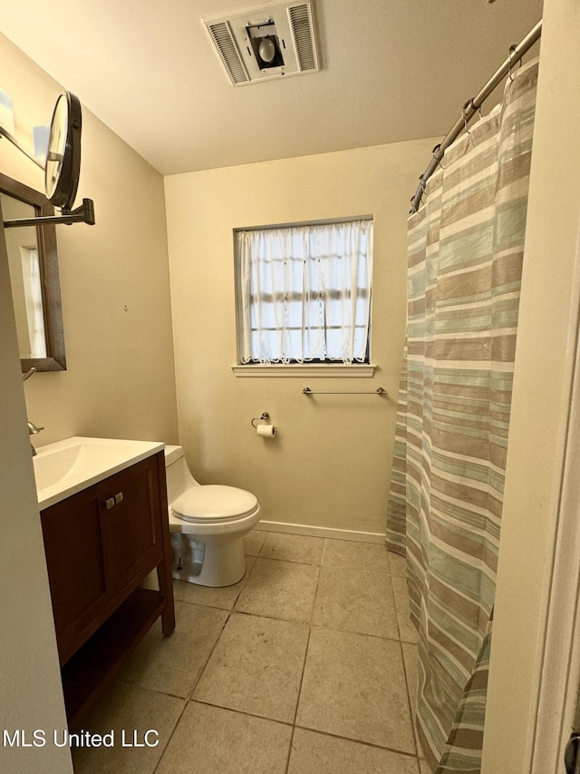 bathroom featuring visible vents, baseboards, toilet, tile patterned flooring, and vanity