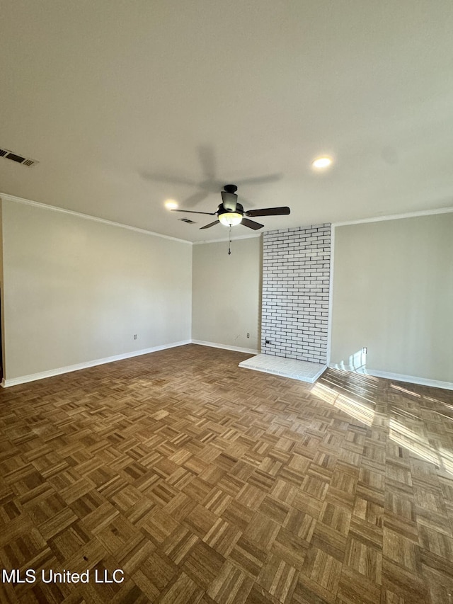 unfurnished room with ceiling fan, visible vents, and ornamental molding