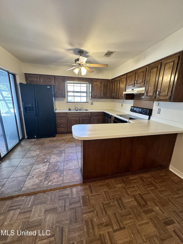 kitchen with visible vents, range with electric cooktop, a peninsula, black refrigerator with ice dispenser, and light countertops