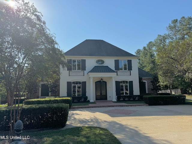 view of front of home with metal roof, french doors, and a standing seam roof