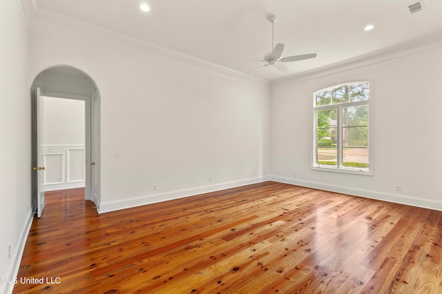 empty room with hardwood / wood-style floors, crown molding, and ceiling fan