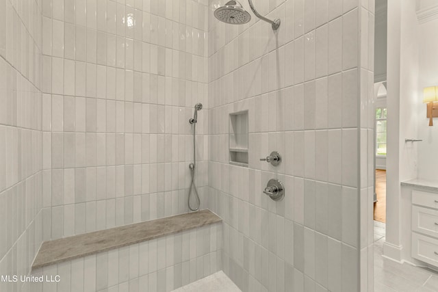 bathroom with a tile shower