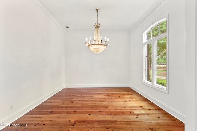 unfurnished room featuring ornamental molding, light hardwood / wood-style flooring, and a healthy amount of sunlight