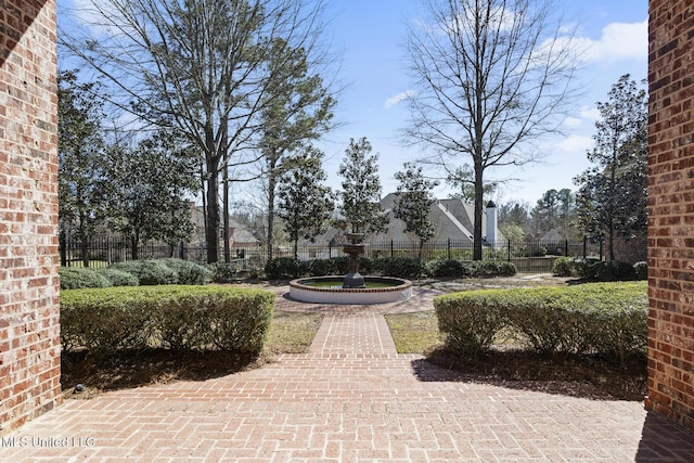 view of home's community featuring fence