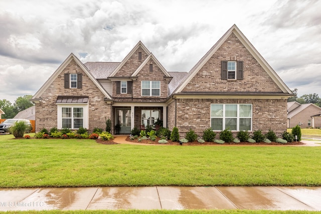 craftsman inspired home featuring brick siding and a front yard