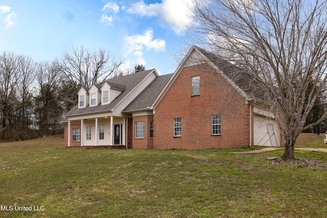 cape cod house with a porch, an attached garage, brick siding, roof with shingles, and a front yard