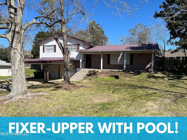 tri-level home with an attached garage, covered porch, brick siding, fence, and a front yard