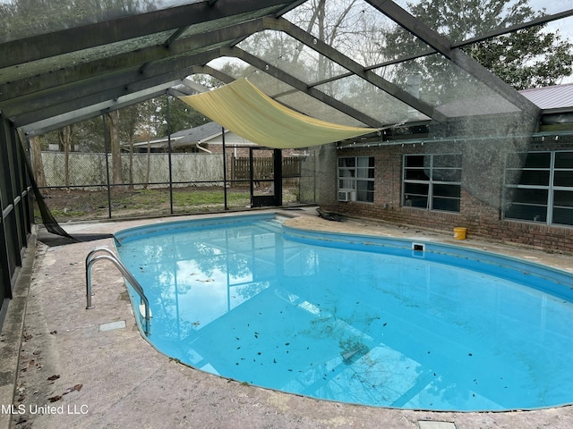 view of pool featuring glass enclosure, fence, and a fenced in pool