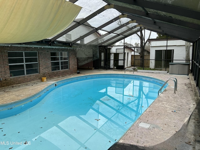 view of swimming pool with a fenced in pool, a storage unit, a patio area, fence, and an outdoor structure