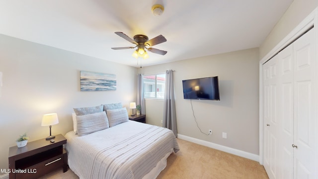 carpeted bedroom featuring a closet and ceiling fan