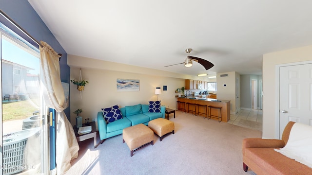 living room with ceiling fan and light colored carpet