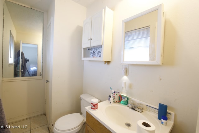 bathroom featuring toilet, tile patterned floors, and vanity