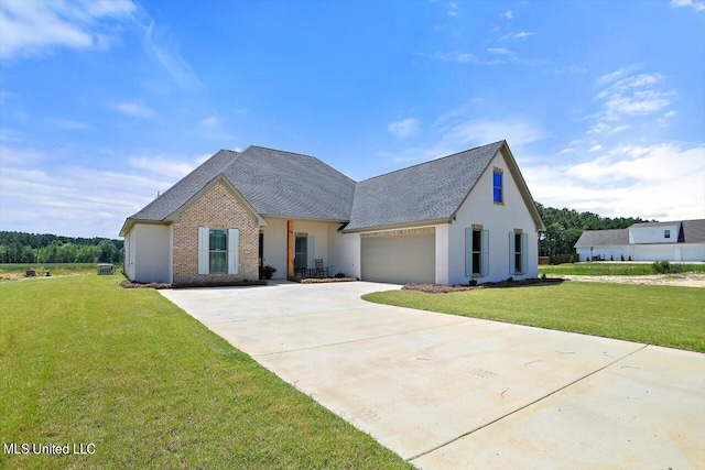 view of front of property featuring a front yard and a garage