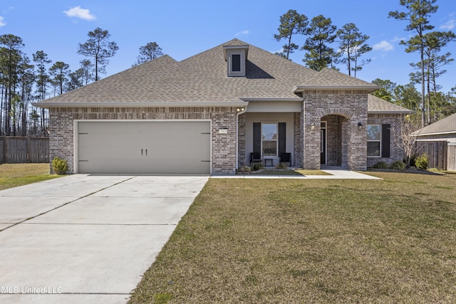 french provincial home featuring brick siding, roof with shingles, a front lawn, and fence