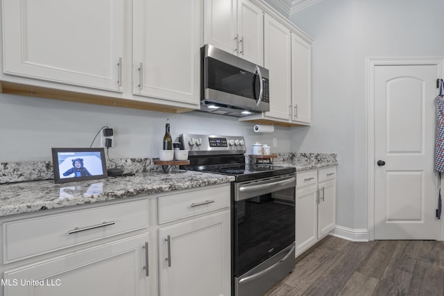 kitchen featuring light stone counters, appliances with stainless steel finishes, dark wood-style floors, and white cabinetry