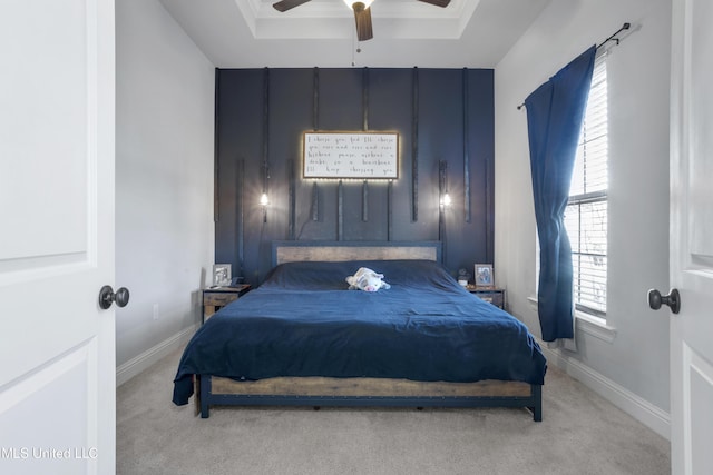 bedroom with a raised ceiling, baseboards, and carpet floors